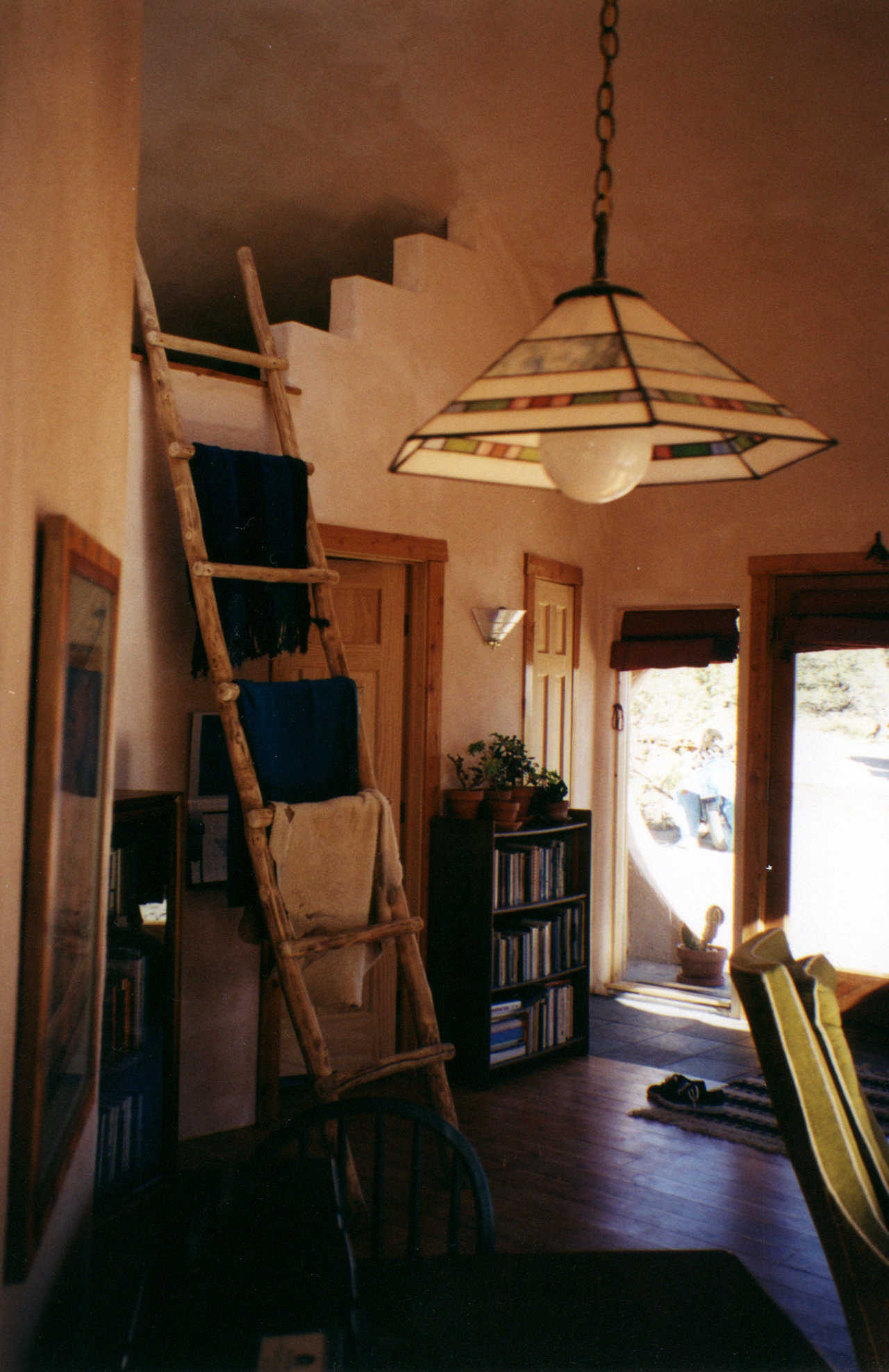 Ananur in the Sangre De Cristo Mountains, Colorado — A ladder joins the two levels of this 35′ × 15′ sphere, built at 8500 feet above sea level and heated only with a 30,000 BTU propane fireplace.