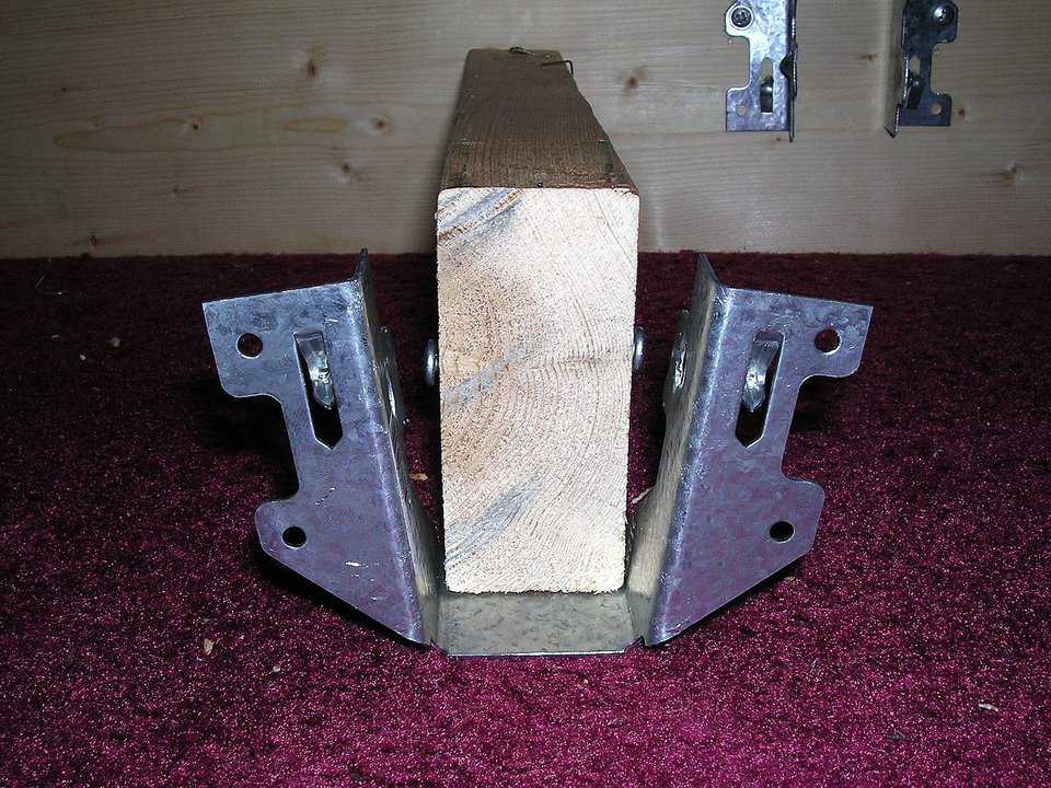 Floor Joist Hanger — Each wooden joist is attached to the concrete wall using standard floor joist hangers.
