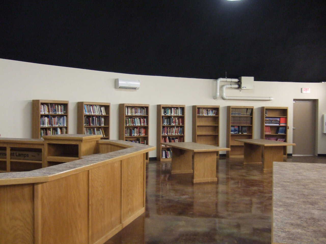 Library — Gradually, books are getting moved over and properly stacked.