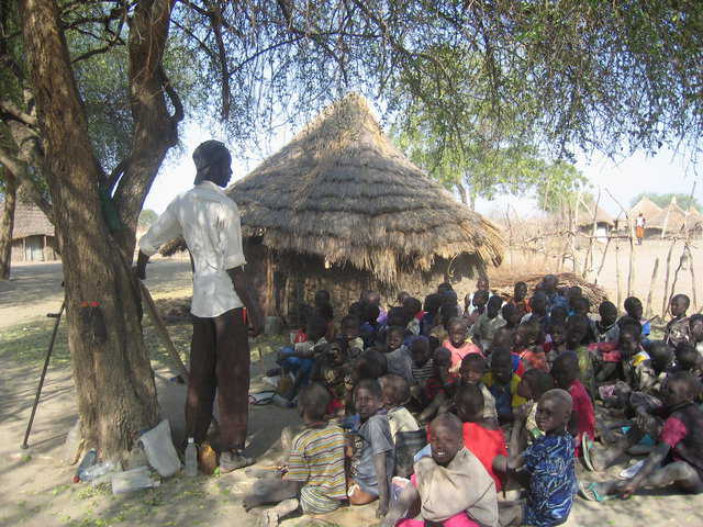 A Southern Sudan school — Typical primary school in Southern Sudan. Inside the mud huts children sit on dirt mounds and are not protected from termites and harsh weather.