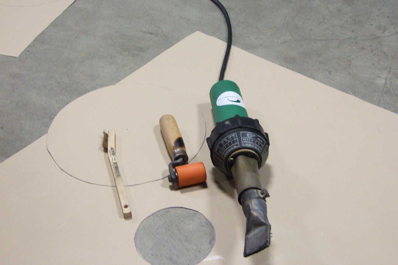 Welding Tools — Here are the tools needed to install a patch using a heat gun. From left to right, we have the industrial heat gun, the hand roller, and a wire brush for cleaning the gun tip.