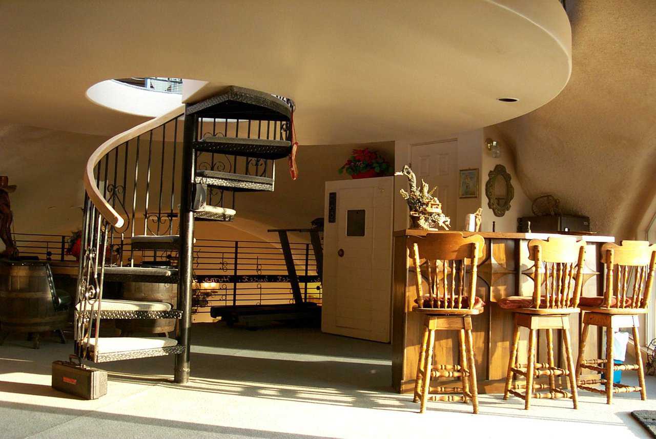 More Spirals — An ornate, spiral staircase leads to the second level.