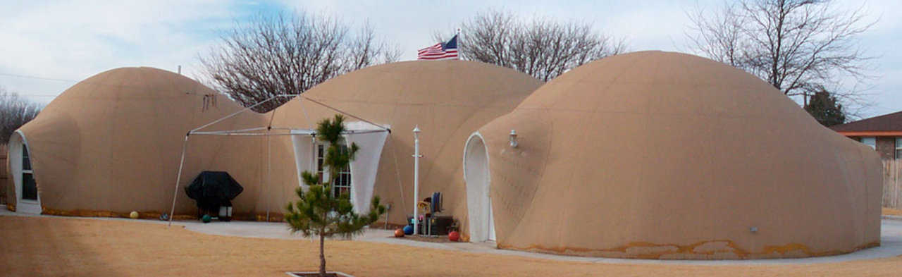 Three-dome home and a dome-garage — The Tuttles’ 2,600-square-foot home consists of a 37-foot diameter dome for the kitchen and great room and two 24-foot diameter domes for bedrooms, bathrooms and office. Their fourth dome shelters their car.