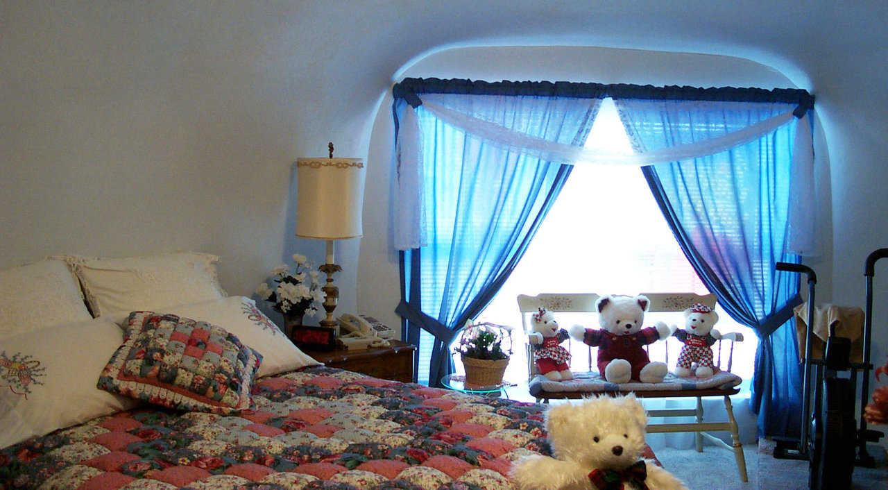 Master bedroom — An assortment of Teddy Bears adds to the comfortable ambiance of this room.