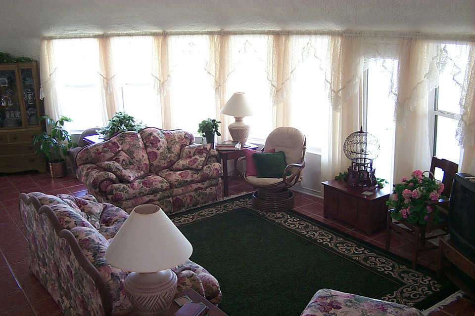 Spacious great room — A wall of windows in Charca Casa’s great room provides light and a view of the patio and pond. This home inspires a feeling of serenity — one that visitors often notice as soon as they enter.