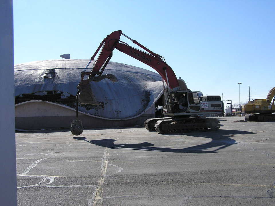 Demolition — Demolition of the Ream’s Turtle took two track-hoes, one equipped with a 5000-pound wrecking ball that continually circled the dome, bashing its concrete.