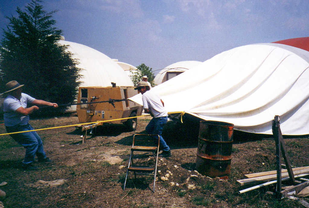 Step 11 — Removal of the Airform will be tough. If this is not so, there will be failure during the construction. The Airform must not let go of the concrete because a cave-in may ensue. Do not use a mold release; it will get you in trouble. The work of pulling the Airform is nothing compared to putting a fallen dome back together. Removal of the Airform can be done by simply pulling it up, bit by bit, around and around. Ropes can be affixed for pulling larger Airforms.