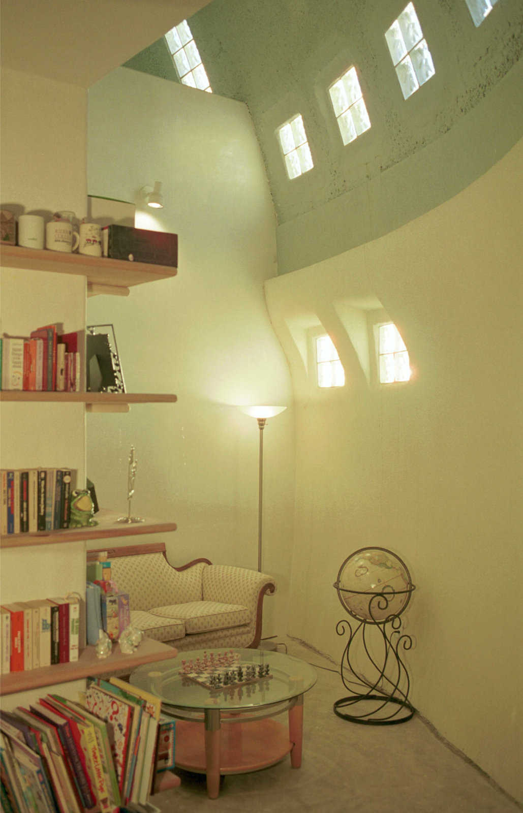 Library — The high ceiling has glass blocks that provide light for this U-shaped library with a secluded reading area.