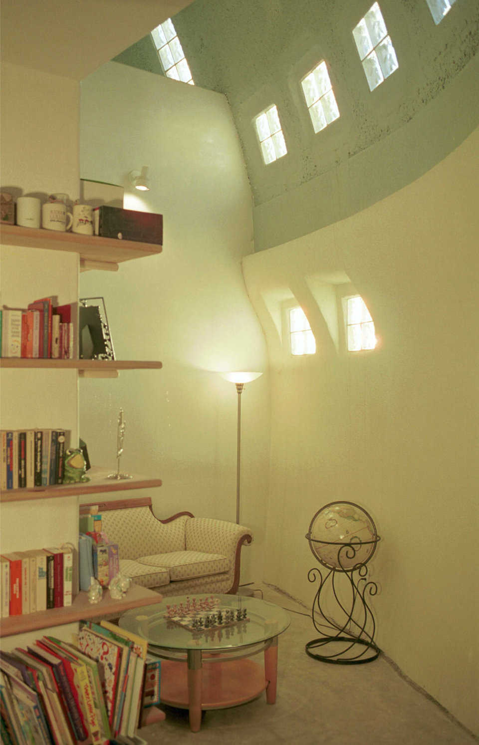 Library — The high ceiling has glass blocks that provide light for this U-shaped library with a secluded reading area.