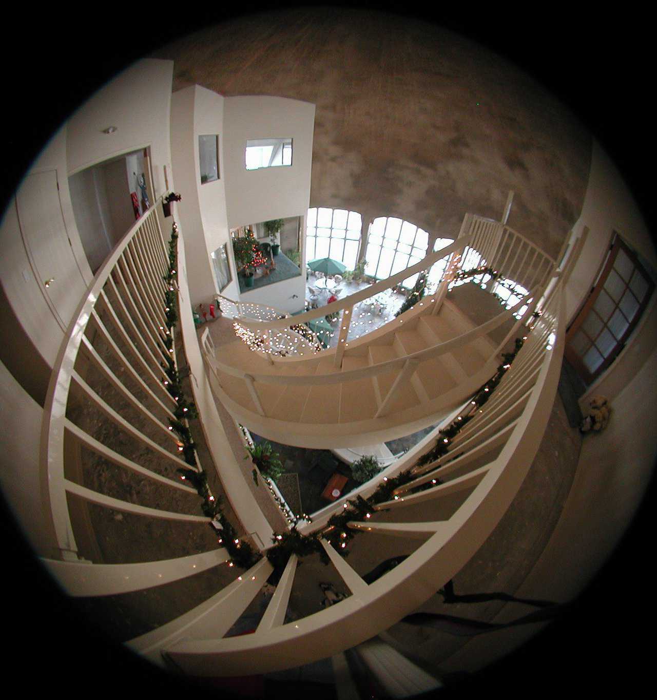 Deck the halls — View from the top using another “fish-eye” lens. Christmas lights and decorations adorn the staircase.