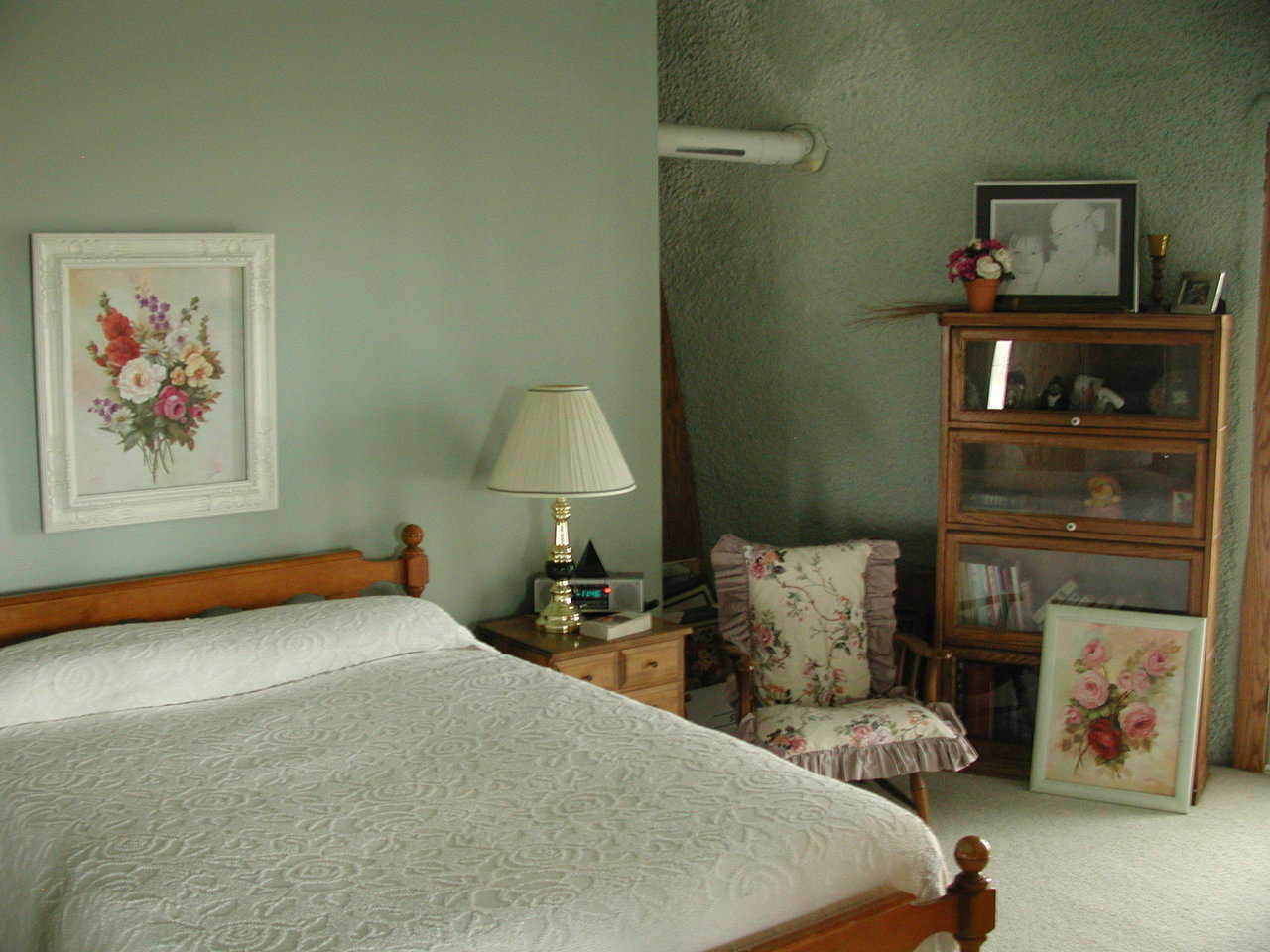 Cozy bedroom — It’s decorated with floral prints.