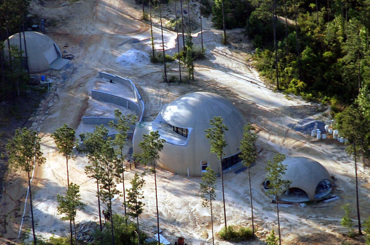 Three Monolithic Domes — In addition to their dome-home, the Simmons have a patio dome and a utility dome. Each is 32′ × 12′.