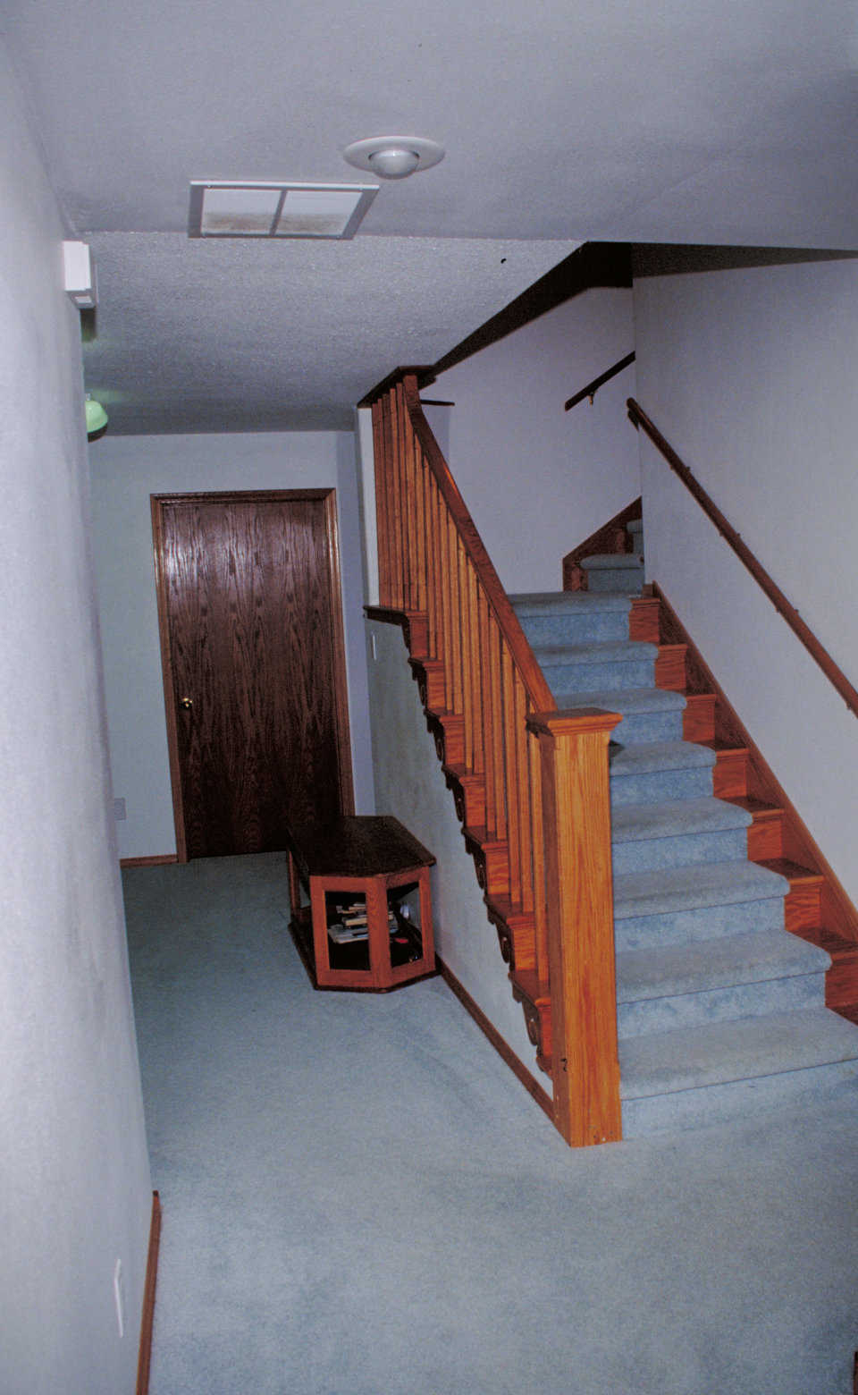 The way up! — This L-shaped stairway includes an attractive, solid oak banister with swirl accents.