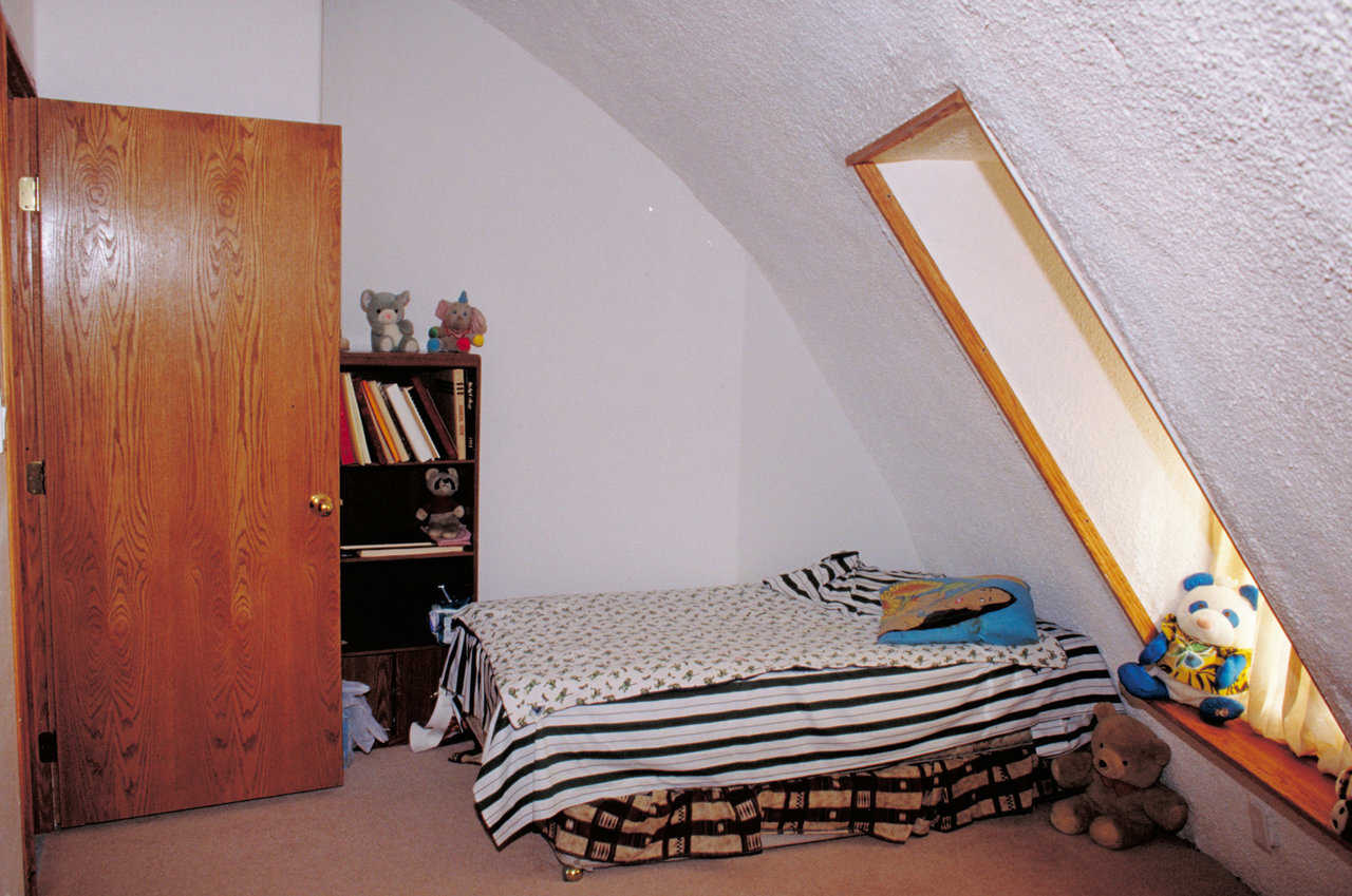 Bedroom — This second-floor bedroom shows how usable the room is even though the dome wall comes in further.