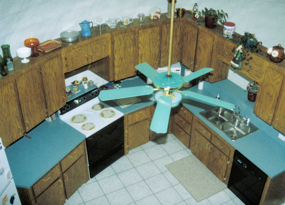 Kitchen — The high ceiling gives an open feeling to the kitchen and provides display space for a variety of glassware and pottery.