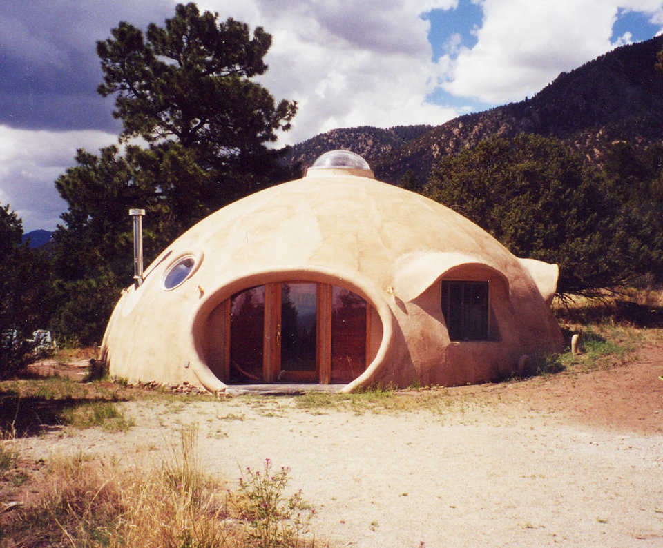 Ananur’s Home — This Monolithic Dome is a 35′ × 15′ sphere. Its exterior is elastomeric Elray stucco. The eyebrows are hand formed out of expanded steel lathe filled with straw.