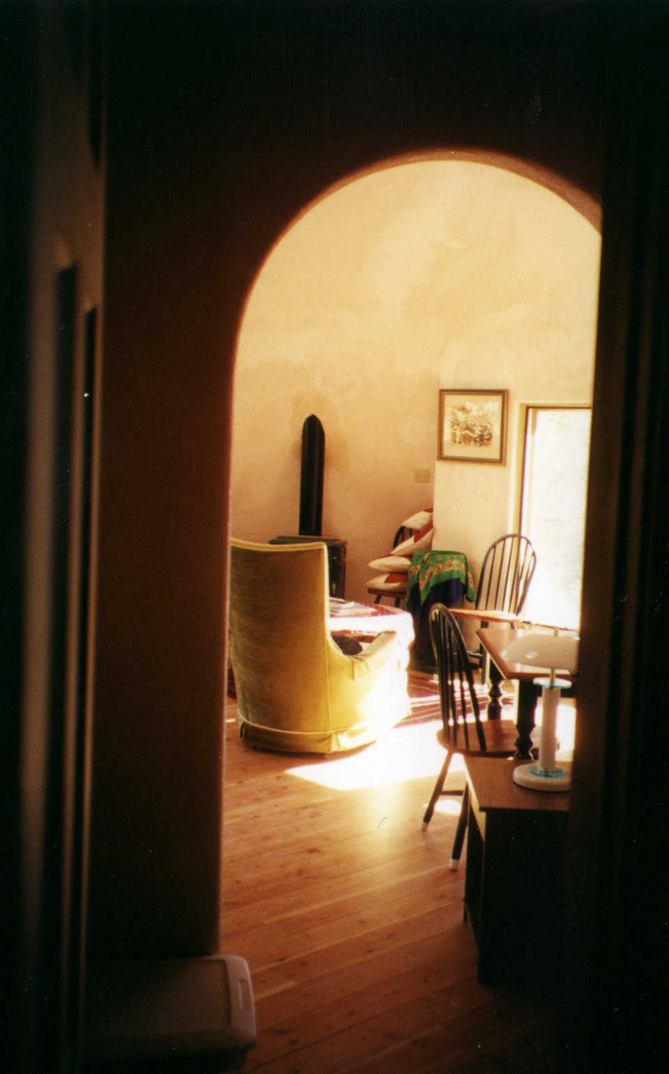 Living rooms — An arched doorway leads to the living area.