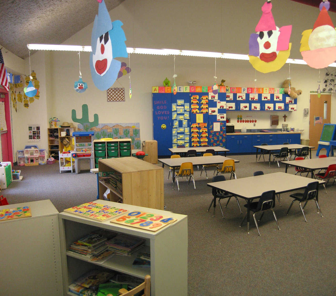 Bright and cheerful — Colorful clown faces hover over the work tables in this kindergarten.