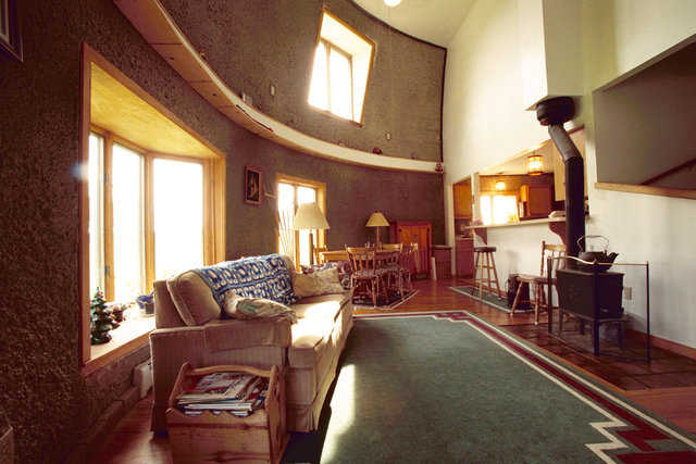 Living room — It’s on the main floor and includes a small, wood-burning stove. The owners are not expecting to use the stove. Instead, they rely on a hot water system running along the floor of each level.