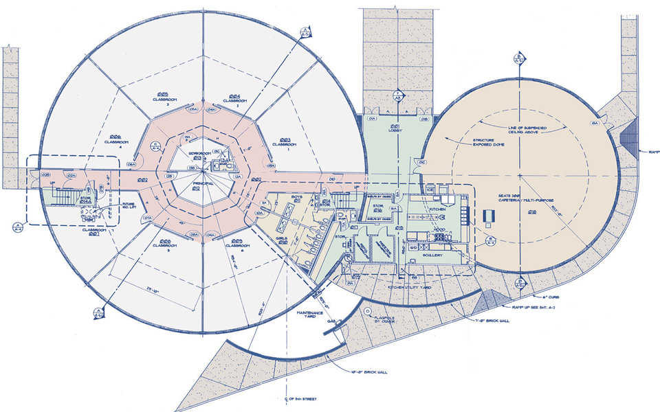 Floor plan — Larger dome encompasses 7 classrooms arranged around a central office area and a large upstairs library. Smaller dome houses a cafeteria and kitchen.