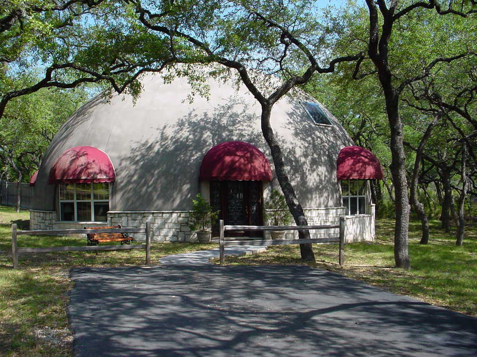 A beautiful Monolithic Dome home — This dream home has a diameter of 50 feet, a height of nearly 29 feet, two stories and 3500 square feet of living space. The dome sits among shady trees on five wooded acres in gently rolling hills.