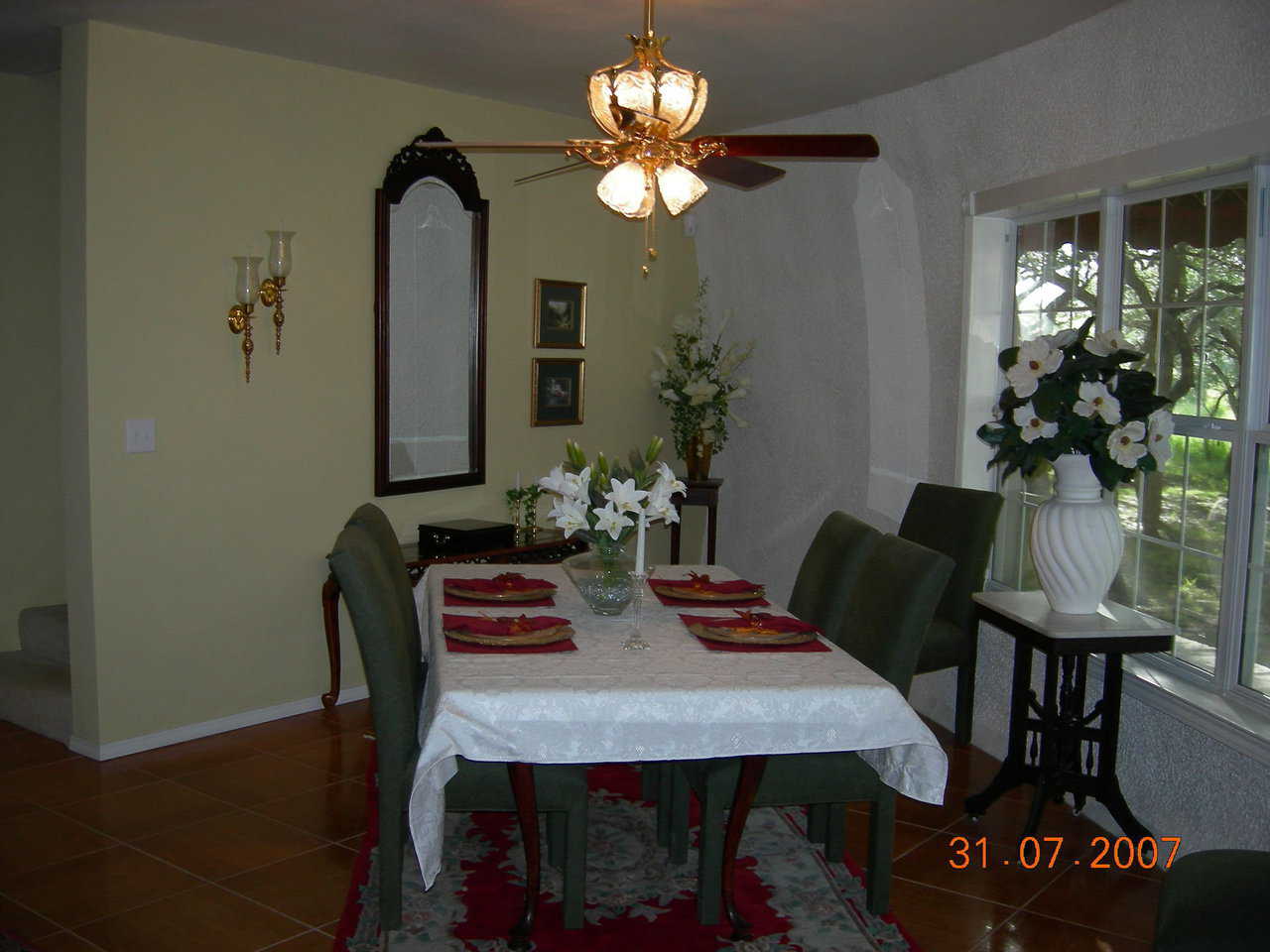 Dining area — Most of the home’s interior walls are painted a soft gold with high-gloss white trim.