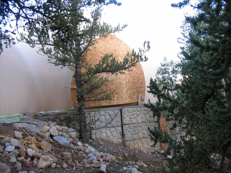 Looking like a giant walnut! — Because the Wortmans’ Monolithic Dome dream home sits at the edge of a cliff, wood, resembling a giant walnut, was used to block an augment so the Airform could be inflated.