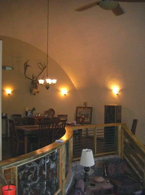 Dining room as seen from sunken living room.  — Keith said, “I firmly believe that lighting makes a home comfortable. I designed all the lighting from what I saw in my dreams for almost 30 years. There are about 15 different combinations that can be used in just this dome alone.”