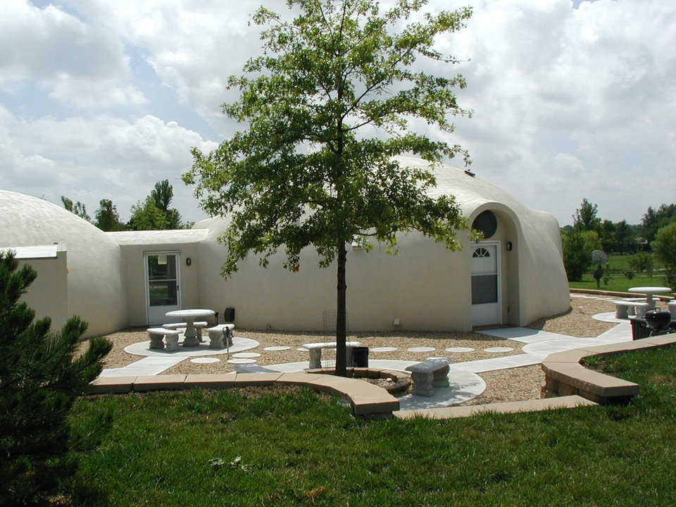 Comfortable Living — Theresa and Patrick enjoy the patio between their dome-home and attached dome-garage.