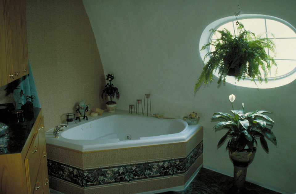 Whirlpool tub — A surrounding shelf makes the tub fit against the dome’s rounded walls.