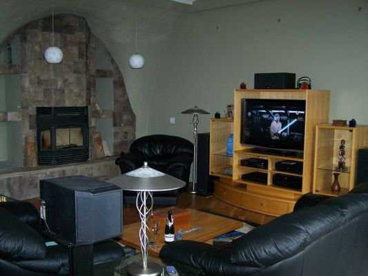 Entertainment area — Besides a wide-screen TV, this entertainment area sports a stone fireplace and soft leather sofas and chairs.