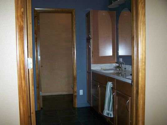 Bath — It includes a marble top double sink and a cultured marble shower with two shower heads, a corner seat, shelves and a grab bar.