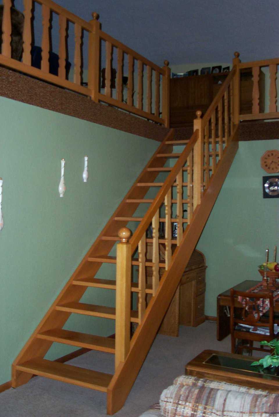 Going up! — The solid wooden staircase matches the wood trim in other areas of the home and leads to the upper loft.