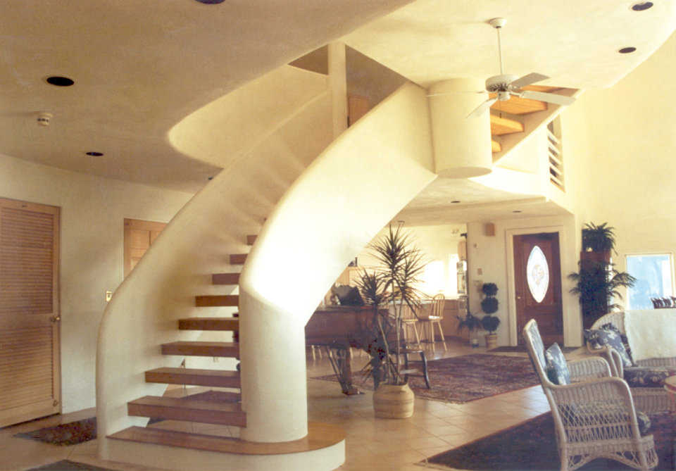 Many curves — The grand staircase to the third level continues the dome’s sculpted and curved design.