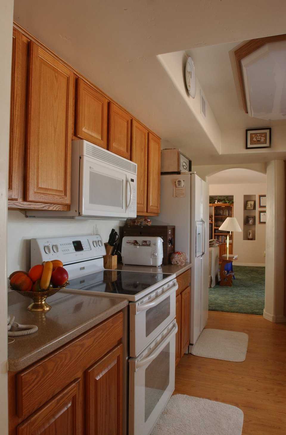 Central kitchen — It’s in the mid-section of the home, providing easy access to both domes. Oak cabinets were bought from a home-improvement store and assembled in sections.