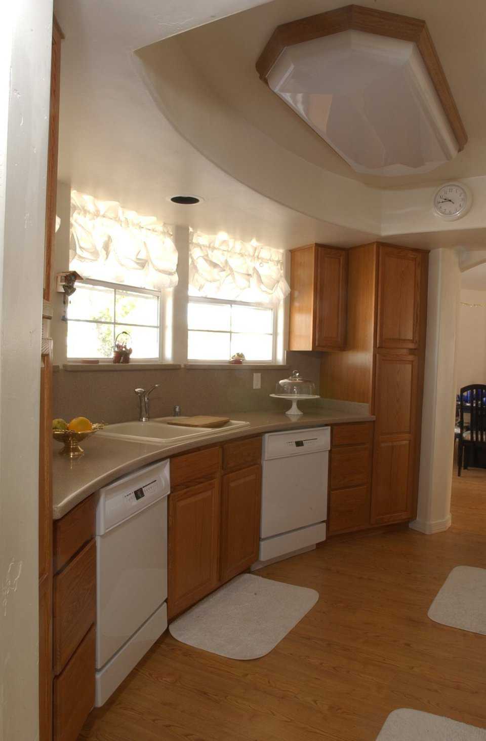 Curvy kitchen — Countertops and cabinets were custom designed to fit the curve of the dome-home’s central core. The countertops are made of Hyplon; it looks like Corian but is much less costly.