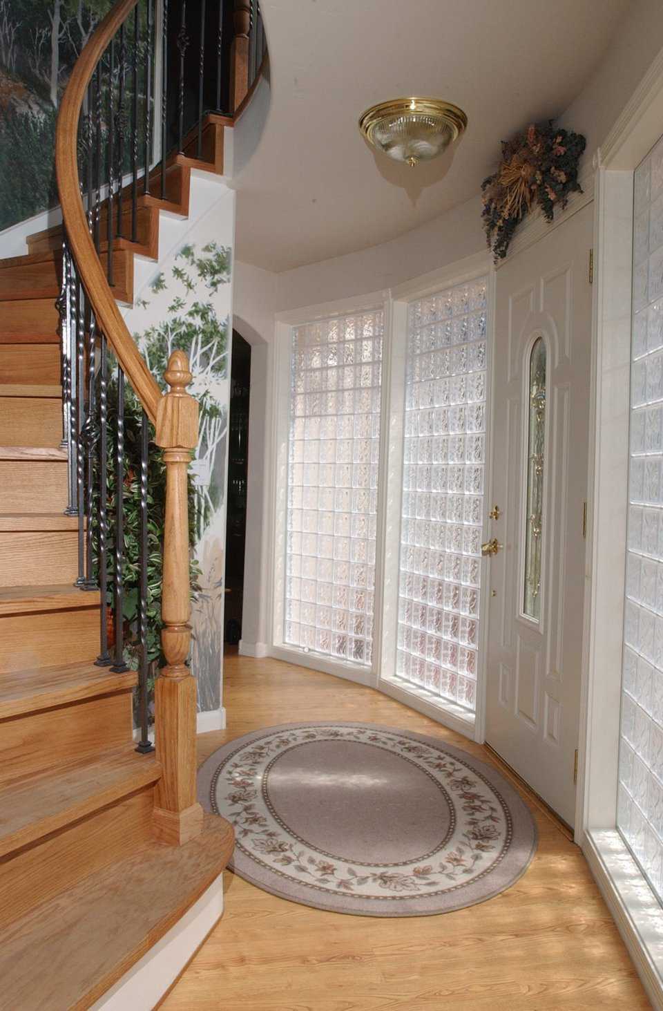 Golden oak wood  — That’s the material used for the spiral staircase, built by “Artistic Stairs,” that leads to the upper level hallway with access to the bedrooms.