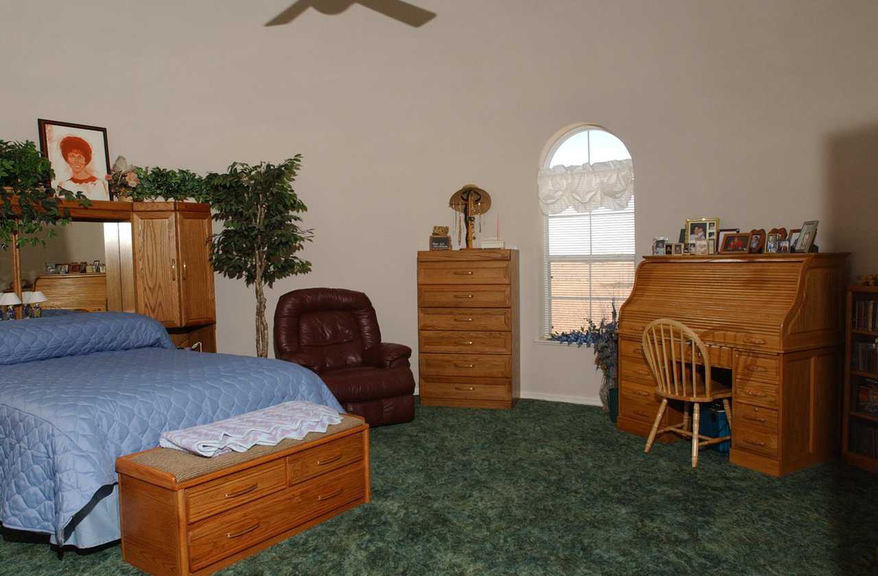 Master bedroom — It has a gracefully arched window and plenty of space for a sitting area and office.