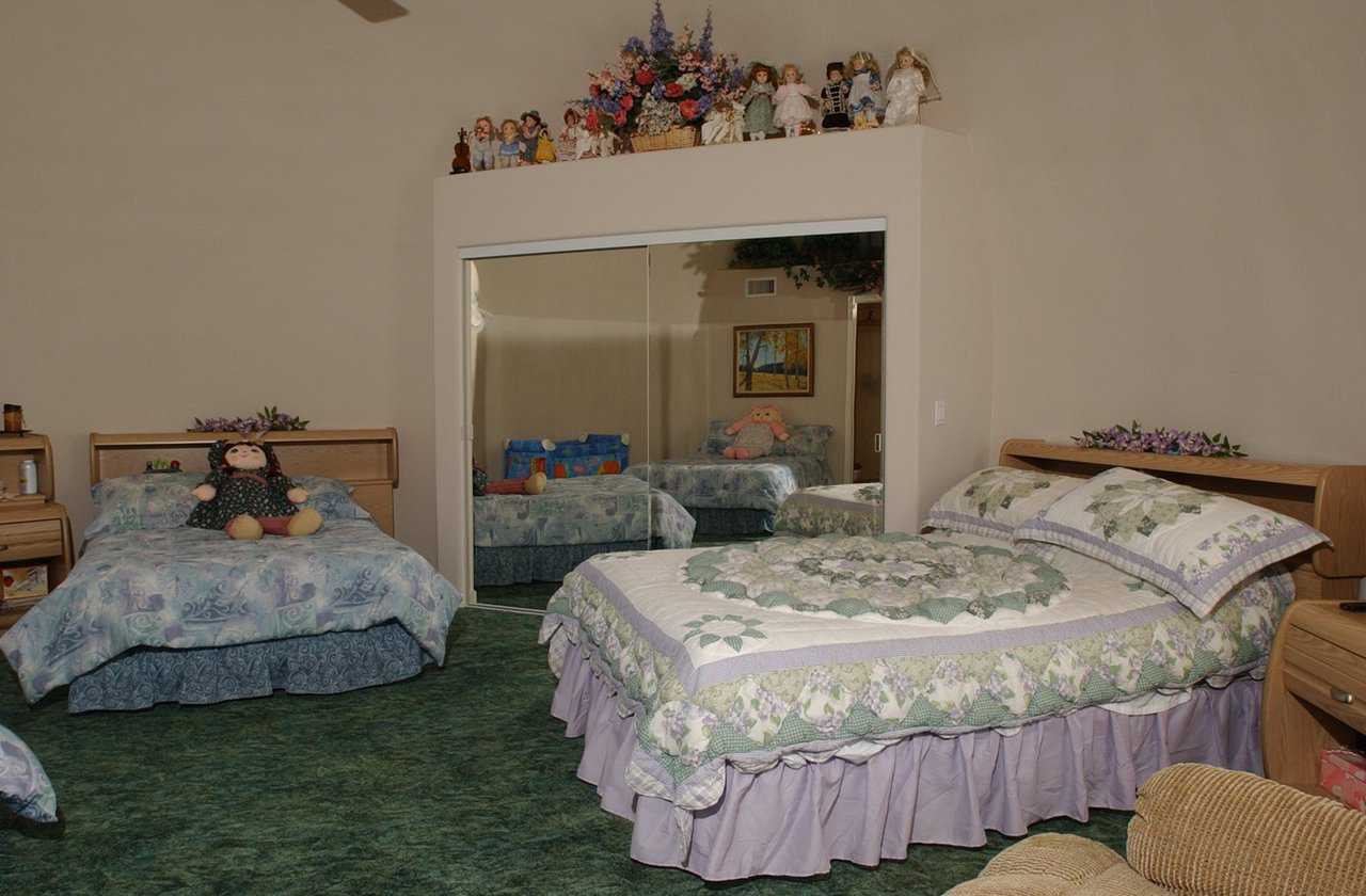 Guest bedroom — It’s large enough for three double beds. The central core of the home is cut back 4 feet into each dome, providing a shelf above the closets.