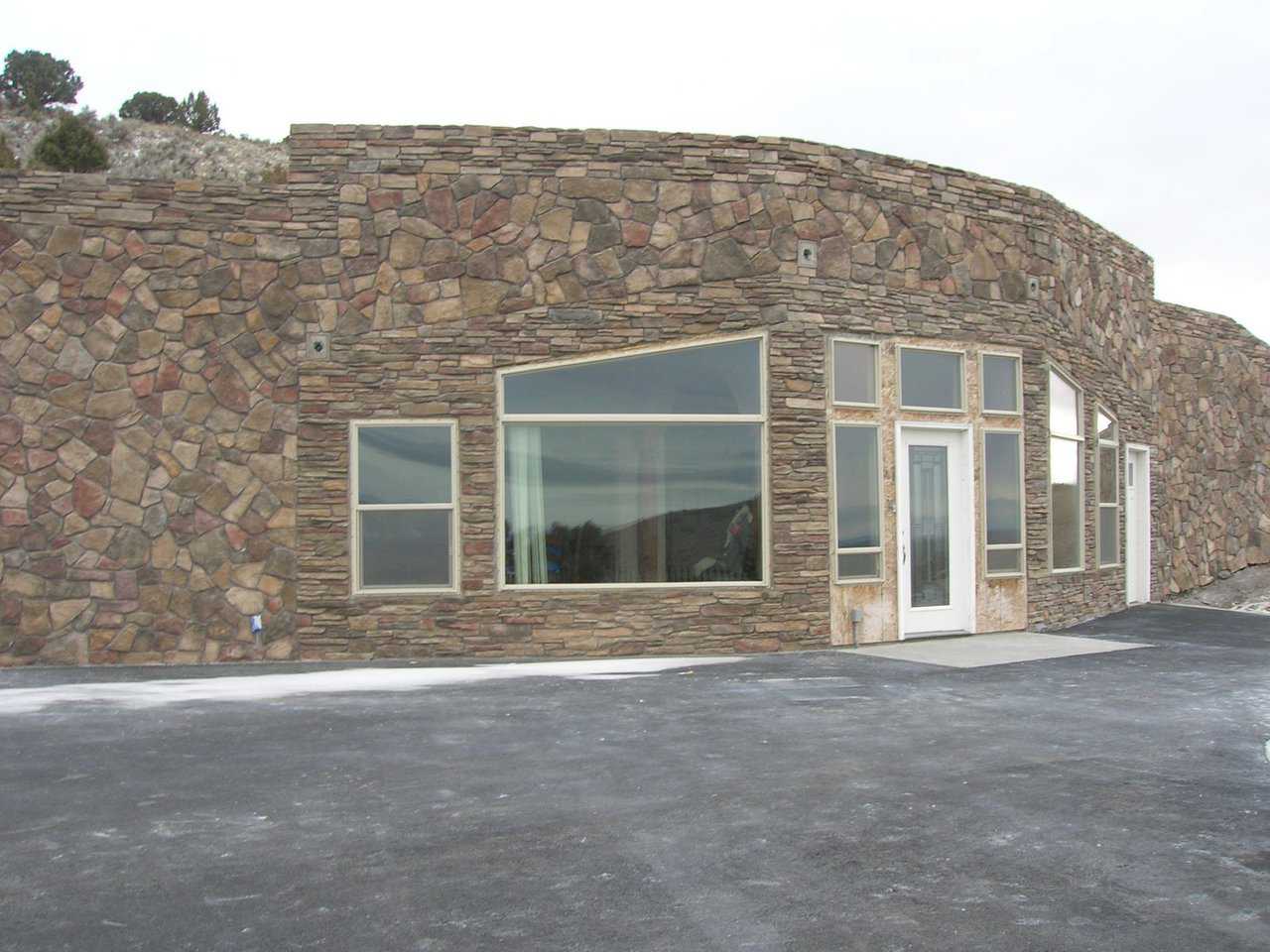 Earth-bermed home — Andrew South and family live in a 3,200-square-foot, Monolithic Dome dream home built into the side of a butte in Menan, Idaho.