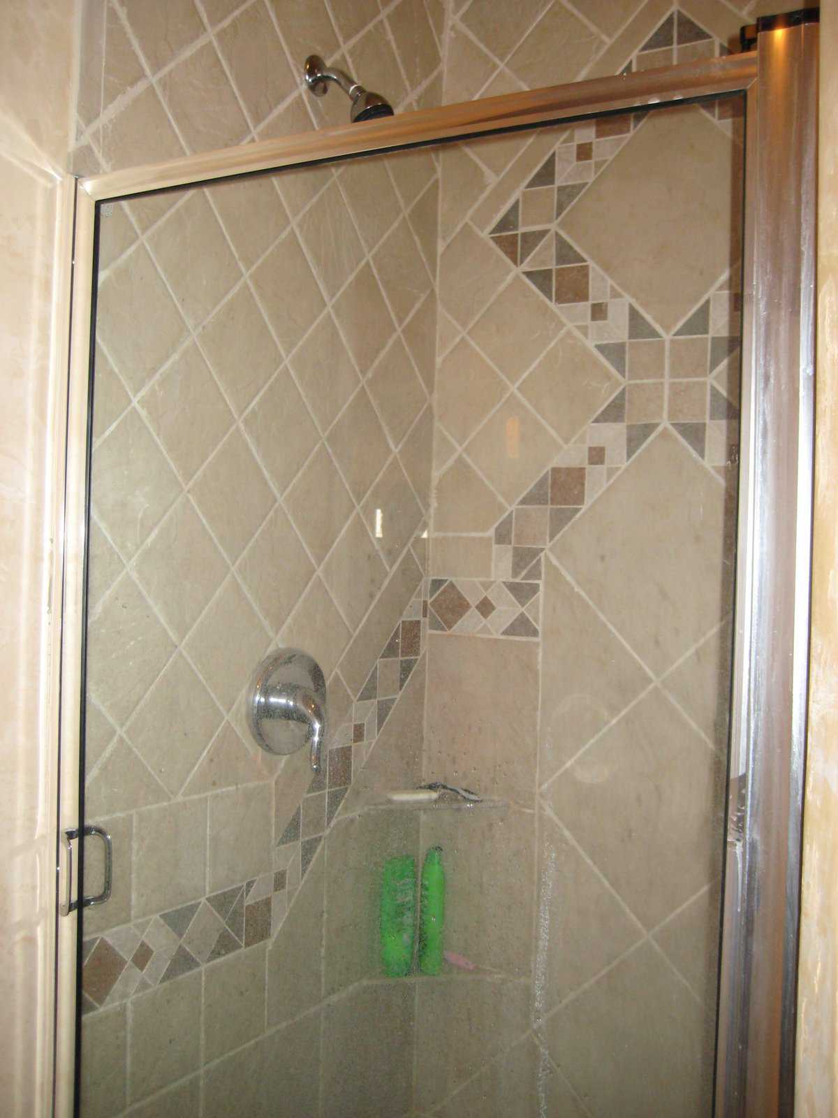 Intricate tile work — Walls with tiles of various colors and sizes form ornate patterns and enclose this shower.