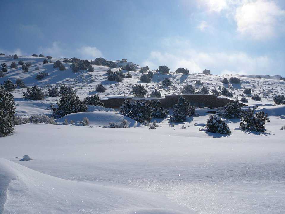 Snow — It covers the visible part of this earth-bermed dome, making it almost invisible.