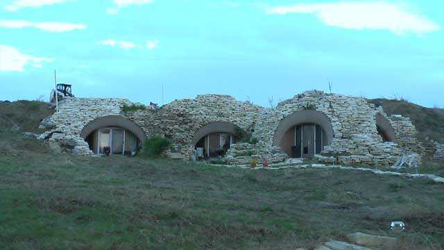 Interconnected domes.  — The visible part of the seven interconnected domes is covered with rock. Rock stepping stones create the pathways too.