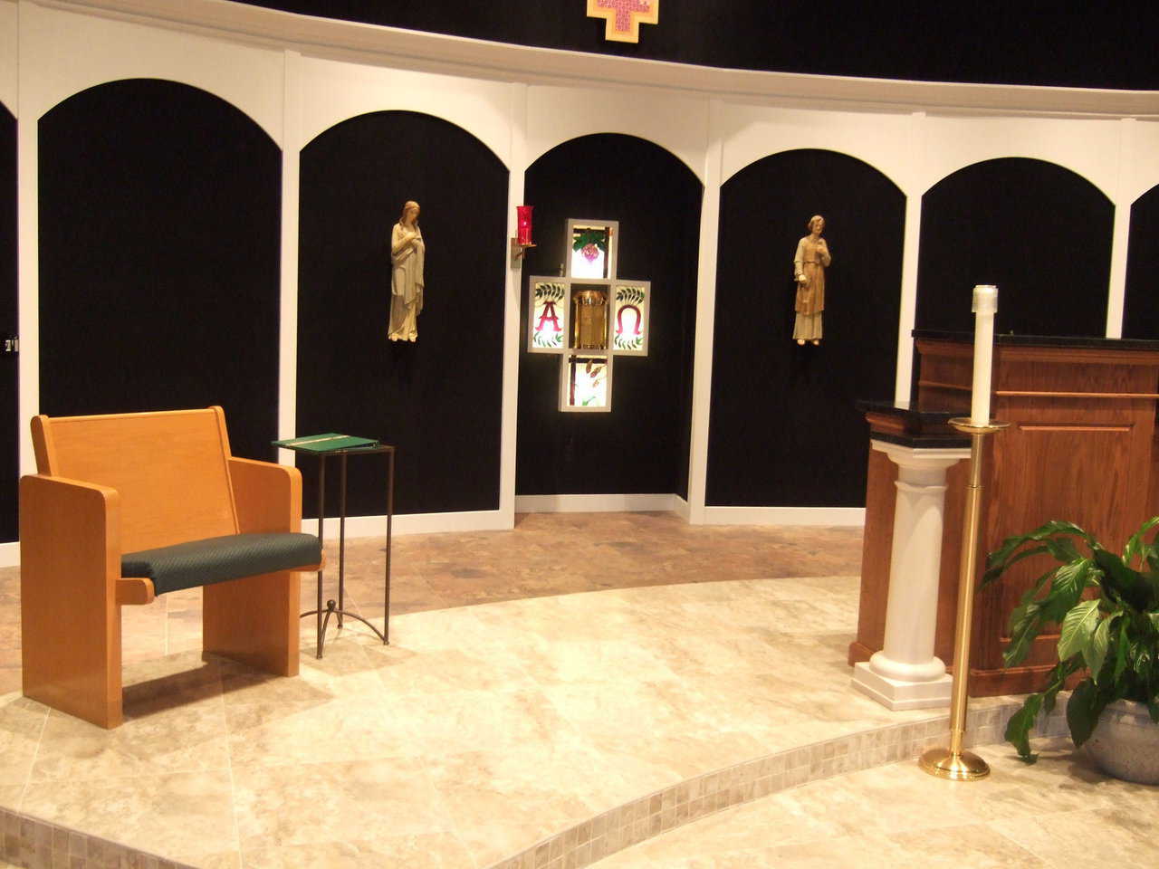 Beloved, familiar items — Two religious statues and four stained glass panels, that were part of St. Joseph’s original church, now adorn the wall in back of the altar at the new church.