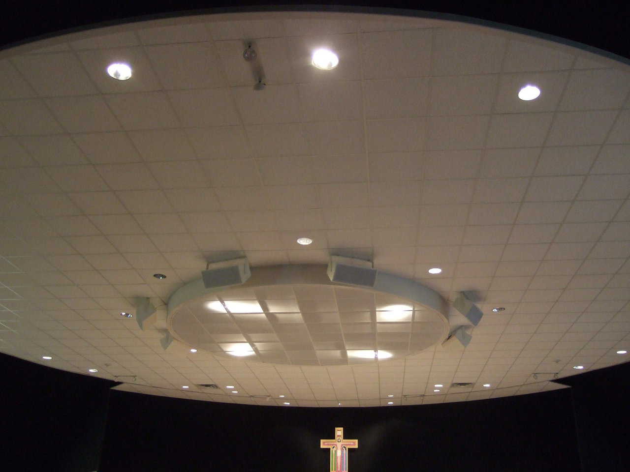 Ceiling — This sparkling white, acoustical, drop-in ceiling is an assembly of rectangular tiles within a circle. Heating and air conditioning equipment sits in the space between the ceiling and the top of the dome.