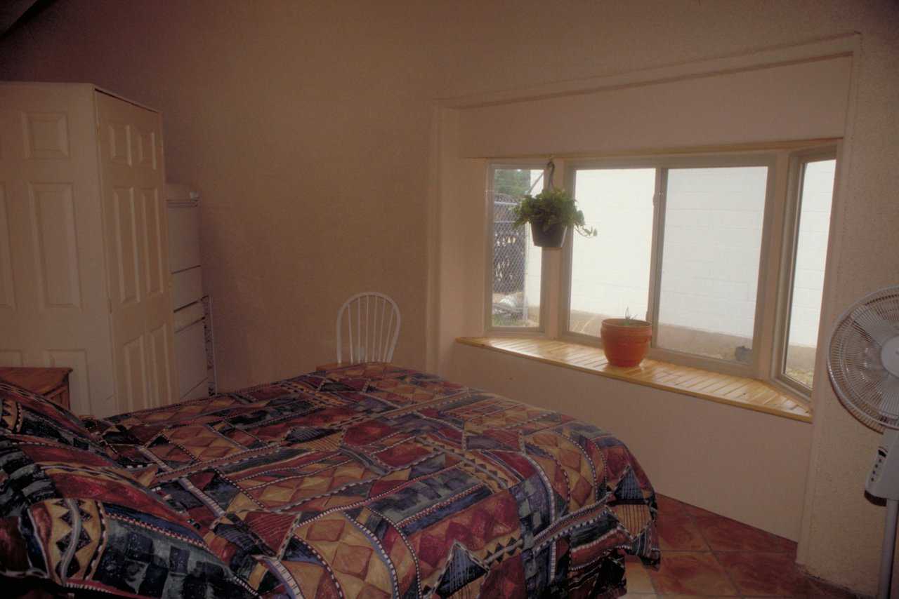 In-floor, radiant heat — During cold Colorado winters, it generates warmth throughout the entire dome. The bedroom’s large bay window offers a delightful view of the outdoors. A space-efficient laundry facility, with a supply cabinet, is tucked into the bedroom’s corner.