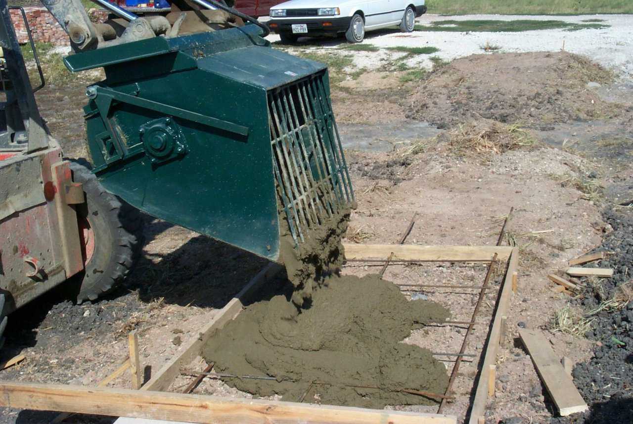 The Monolithic Mixer can discharge concrete by dumping it out, like you would a common skid steer bucket. This can be used to pour side walks, floors, and much more.
