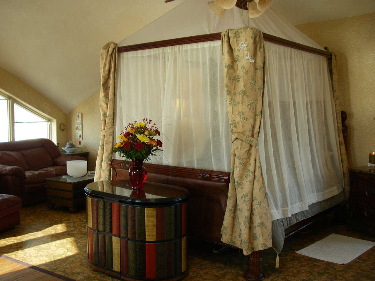 Ultimate privacy — This master bedroom features a canopied, fully curtained queen-size bed.
