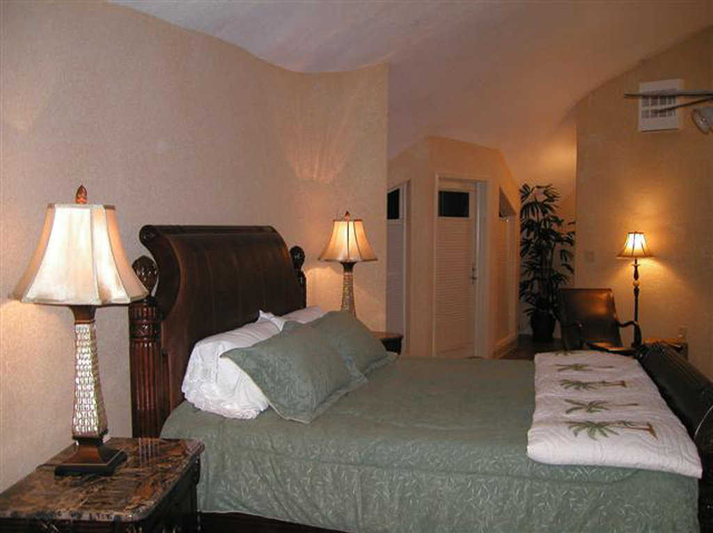 Fifth guest bedroom — It features a sleigh bed and marble topped tables.