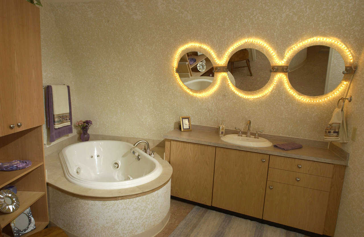 Guest bath — It includes lighted mirrors and plenty of storage space.